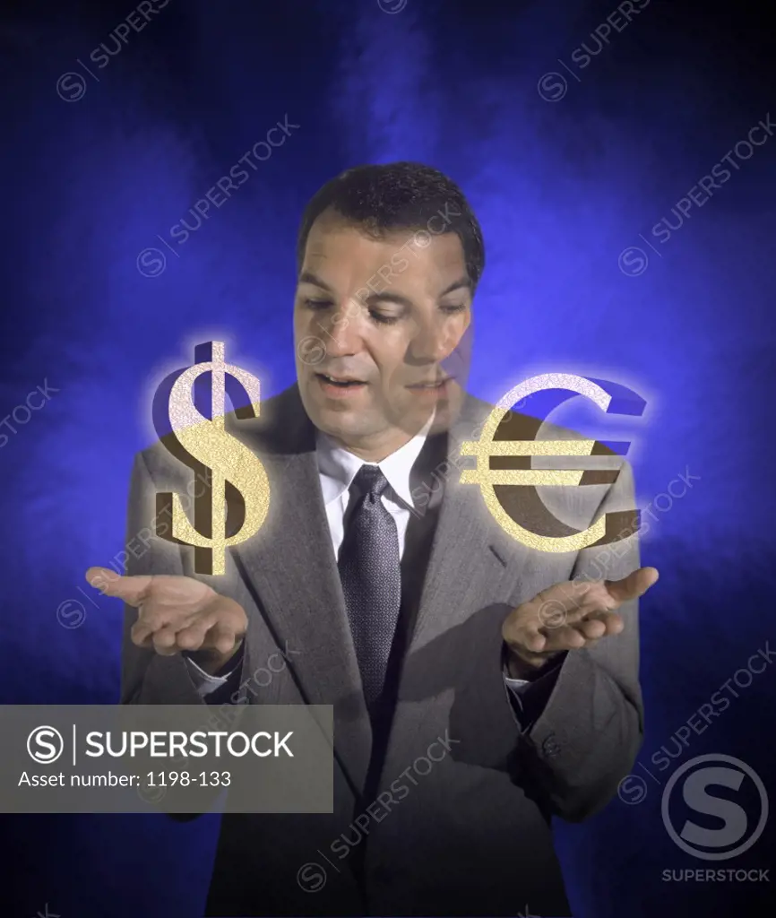 Businessman holding dollar and euro symbols