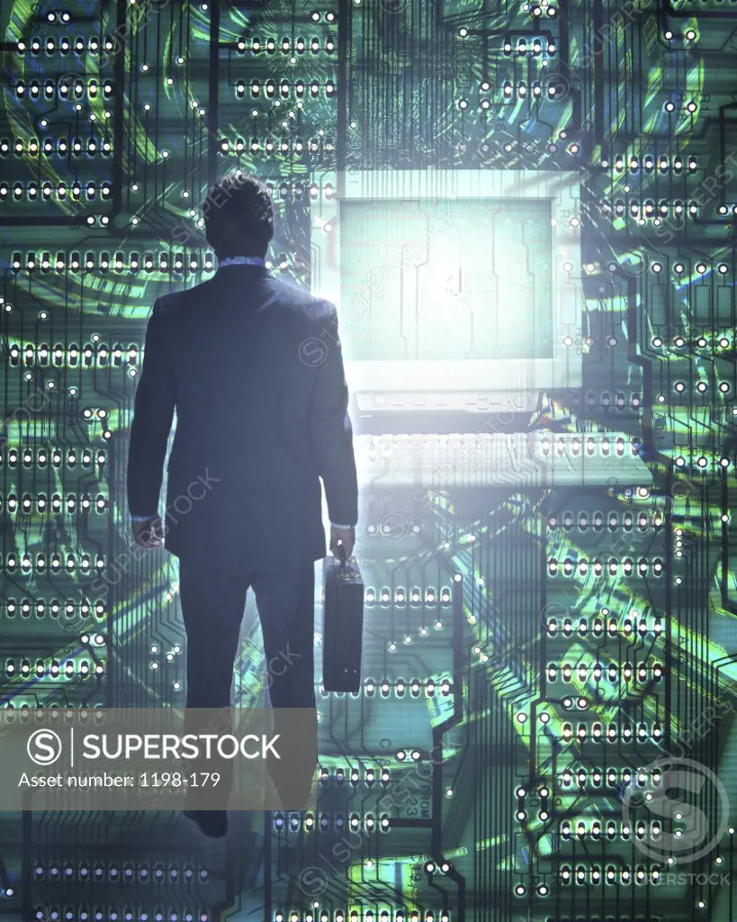 Rear view of a businessman superimposed over a computer chip