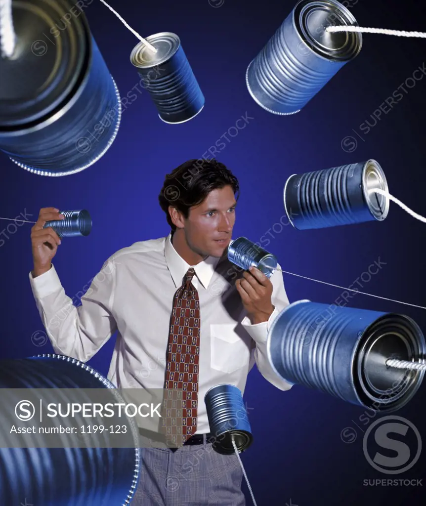 Businessman talking into tin cans