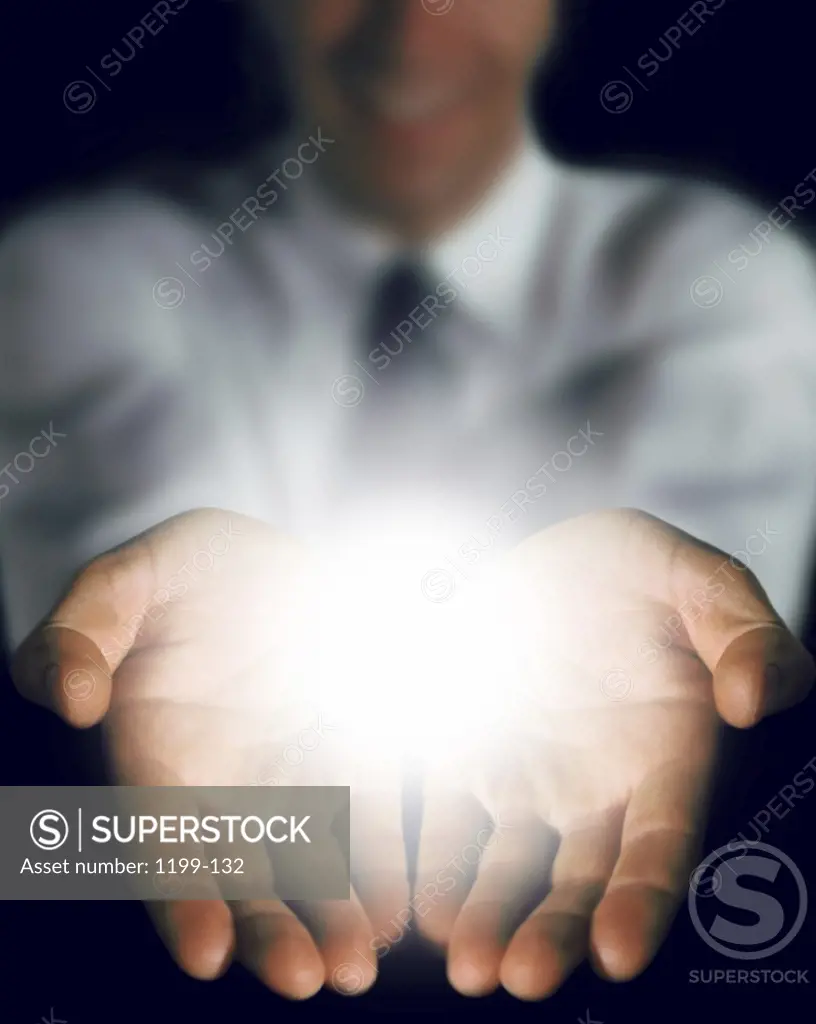 Person's hands with light emanating