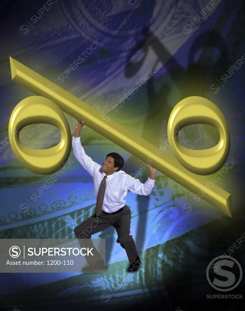 High angle view of a businessman lifting a percent symbol