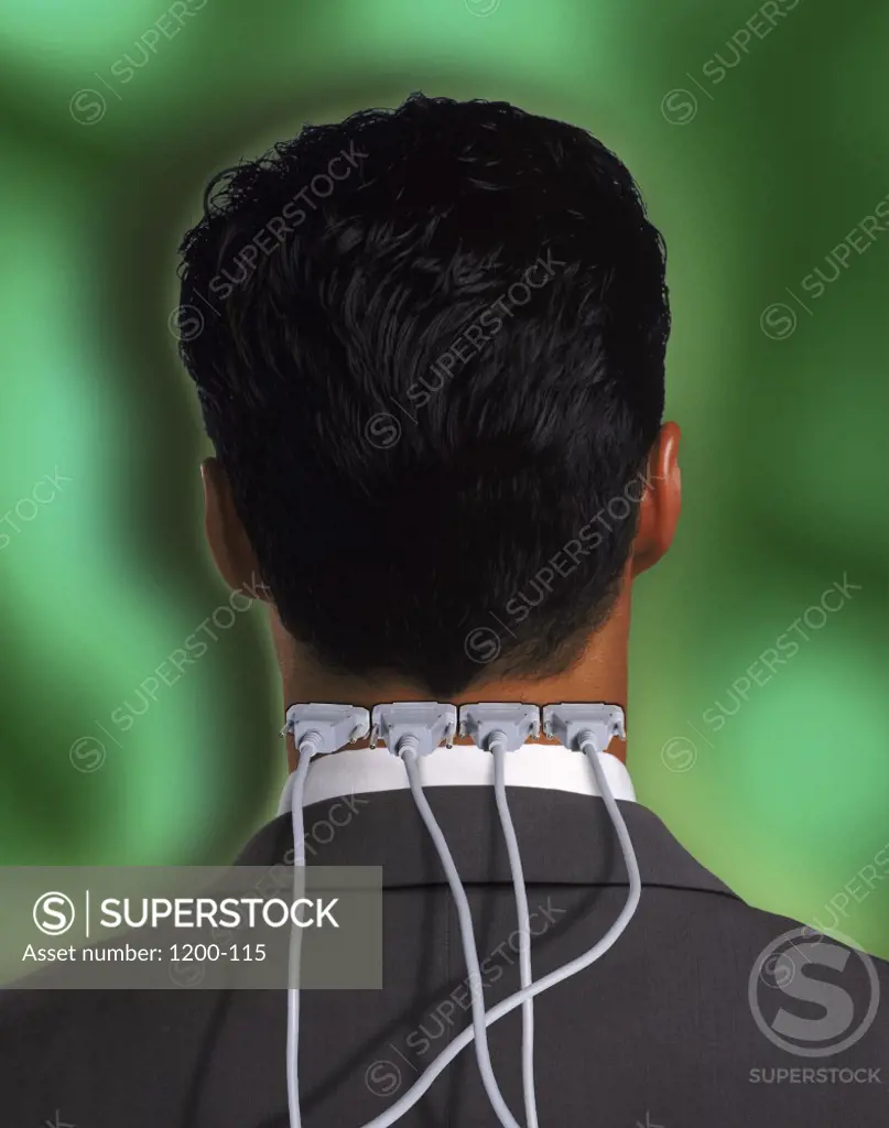 Rear view of a businessman with computer cables in his neck