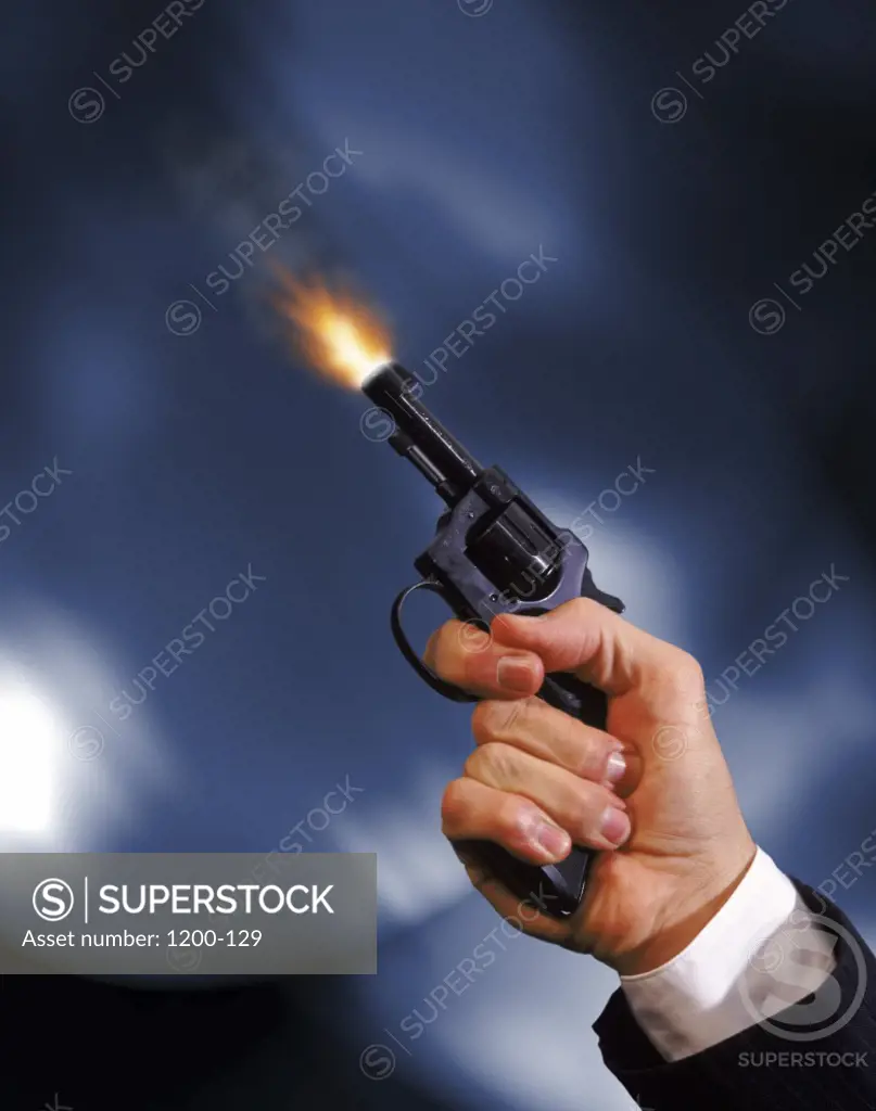 Businessman shooting a handgun