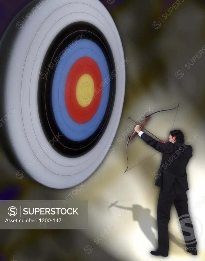 Businessman aiming an arrow at a target