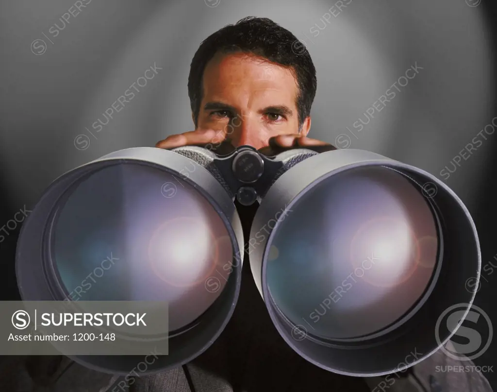 Businessman holding a pair of binoculars