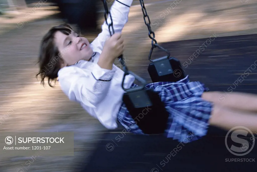 Girl swinging on a swing