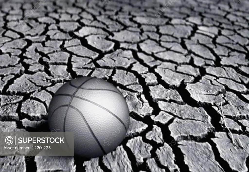 Close-up of a basketball on a cracked surface