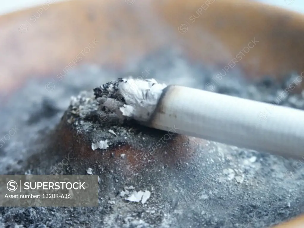 Close-up of a burning cigarette in an ashtray