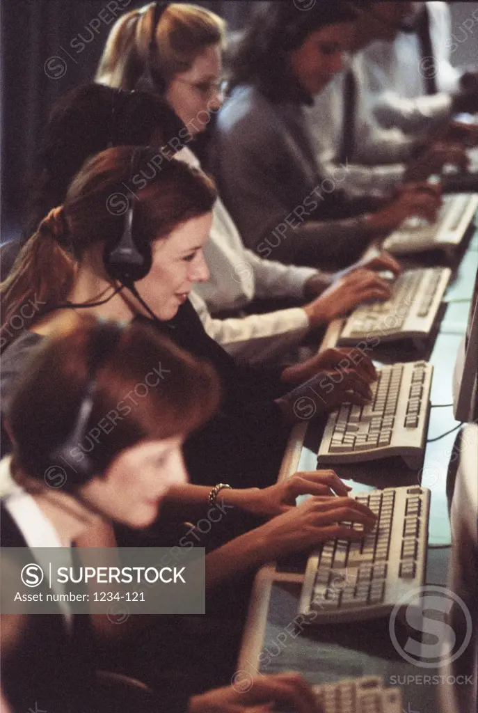 Side profile of a group of customer service representatives working in an office