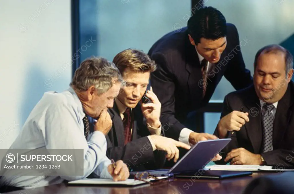 Four businessmen talking in a meeting