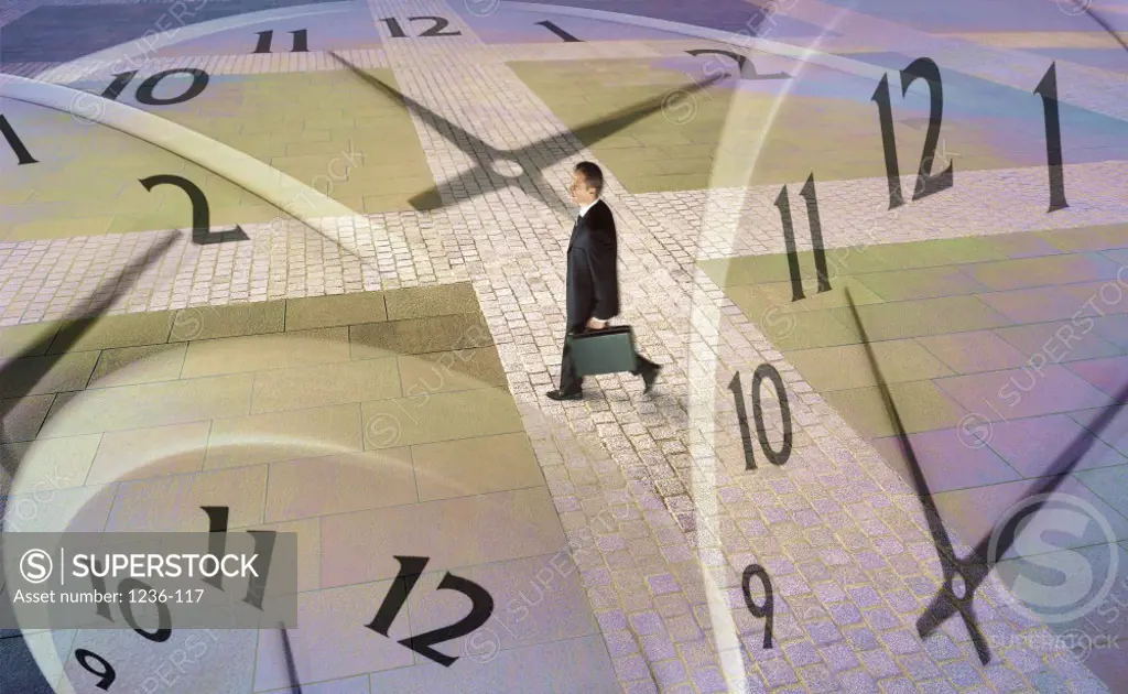 Side profile of a businessman walking over clocks