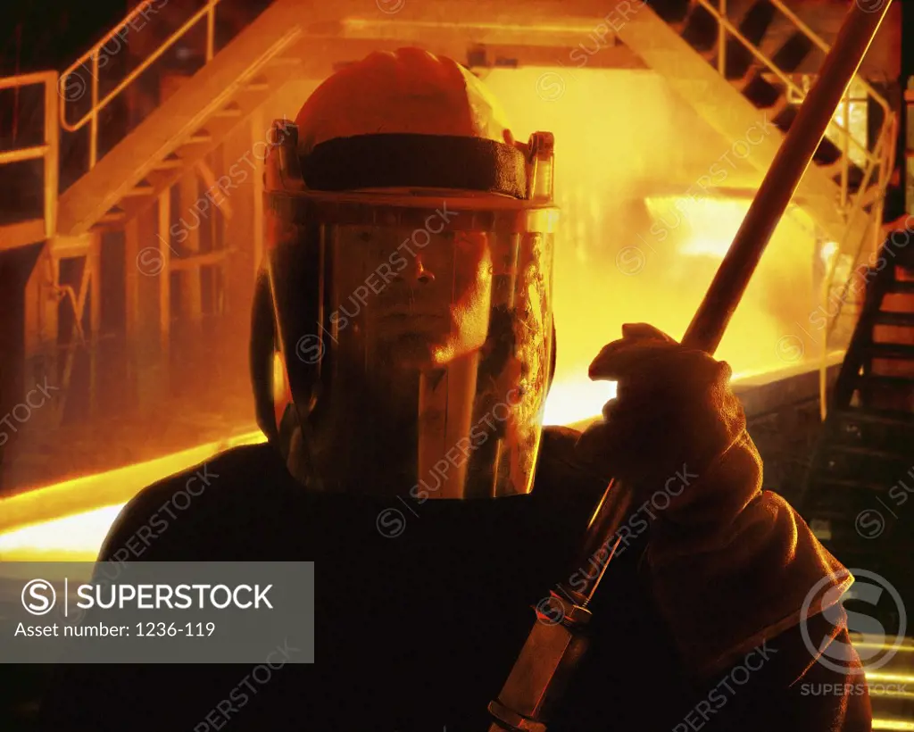 Close-up of a manual worker holding a welding torch