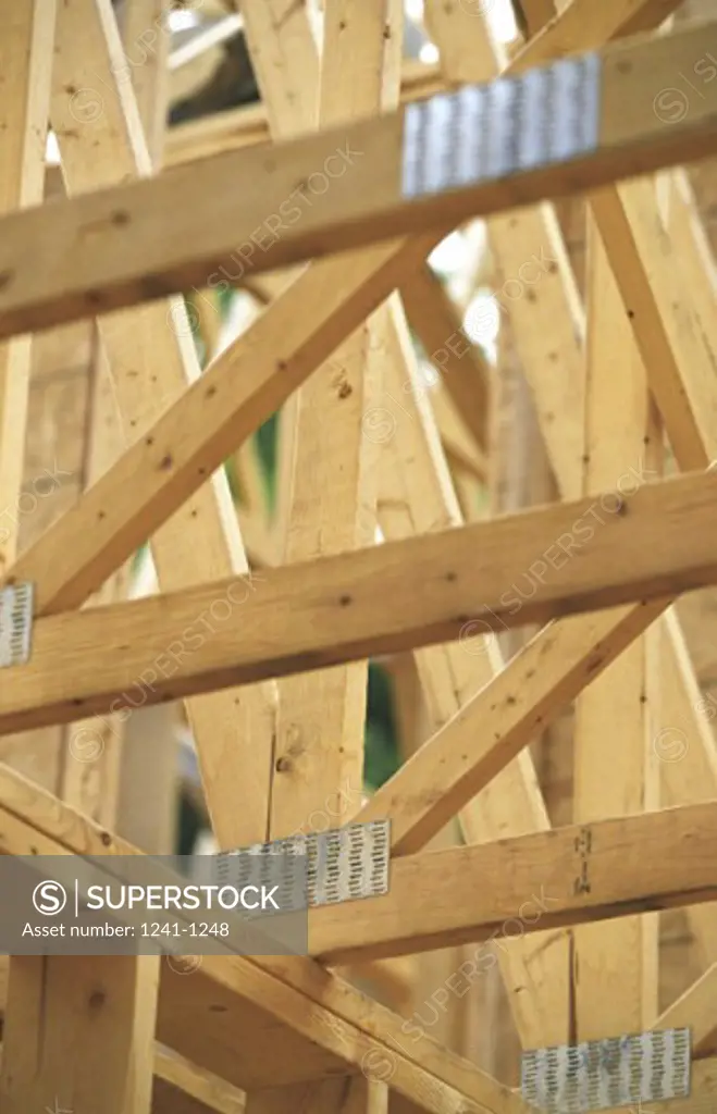 Low angle view of a wooden house under construction