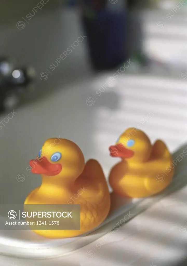 High angle view of two rubber ducks at the edge of a bathroom sink