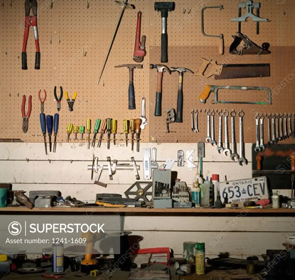 Tools hanging from a pegboard in a workshop
