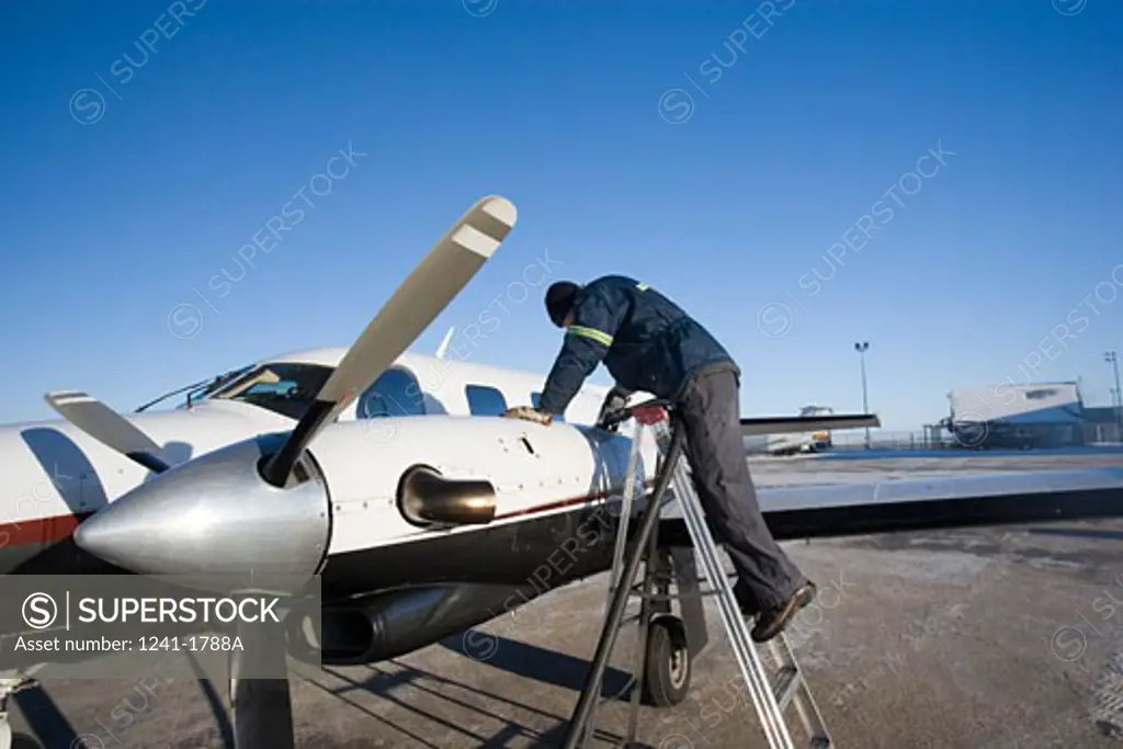 Man refueling an airplane