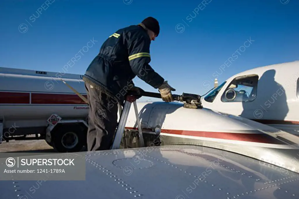 Man refueling an airplane