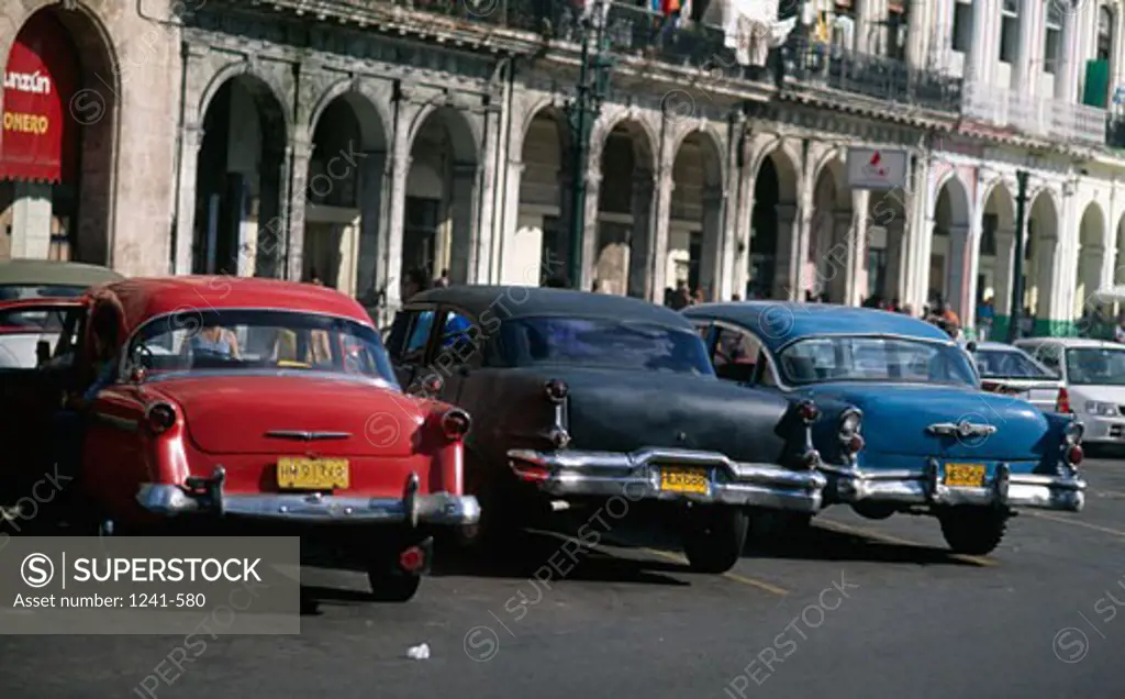 Rear view of vintage cars parked on street,  Havana,  Cuba