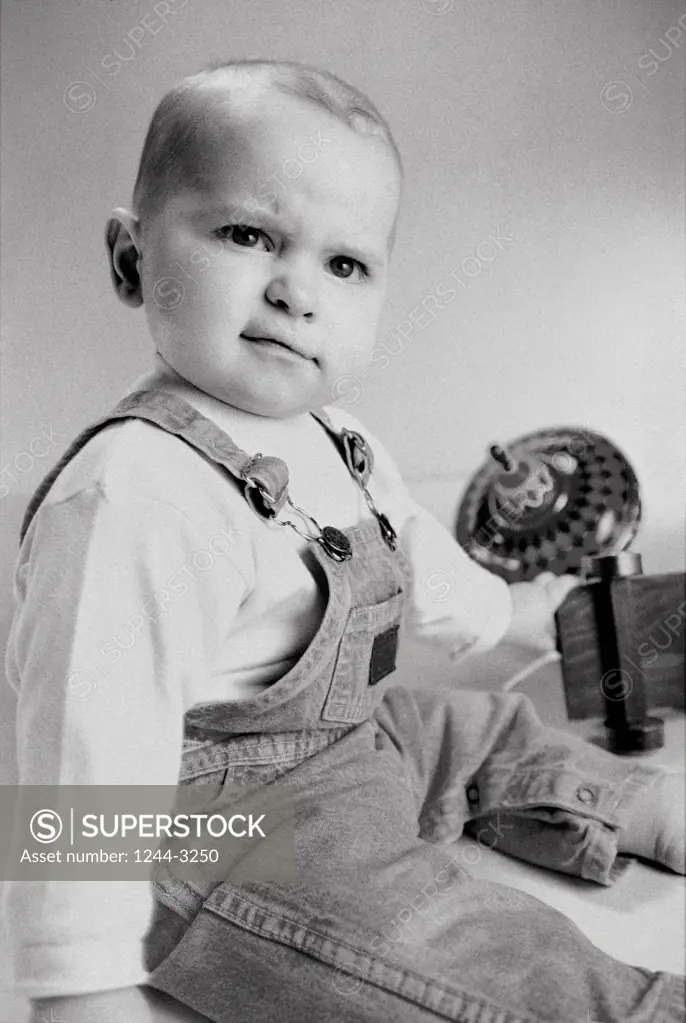 Portrait of a baby boy sitting with toys