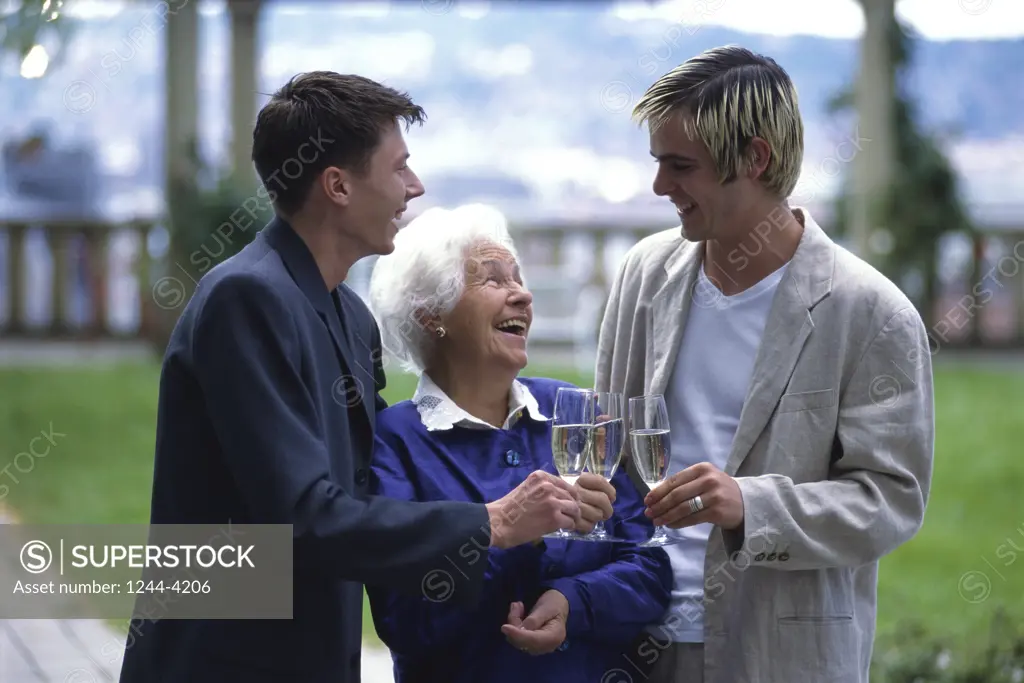 Grandmother and her two grandsons toasting with champagne