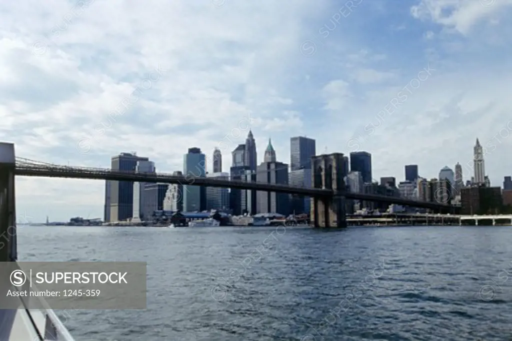 Suspension bridge across a river with skyscrapers in the background, Brooklyn Bridge, Manhattan, New York City, New York, USA