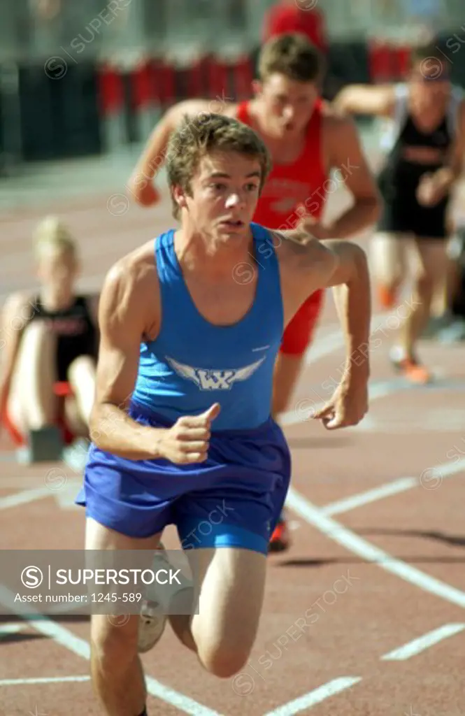 Young man running on a track