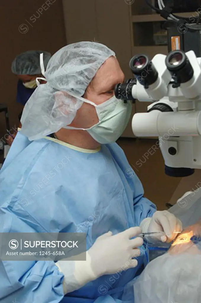 Female surgeon operating on a patient's eye