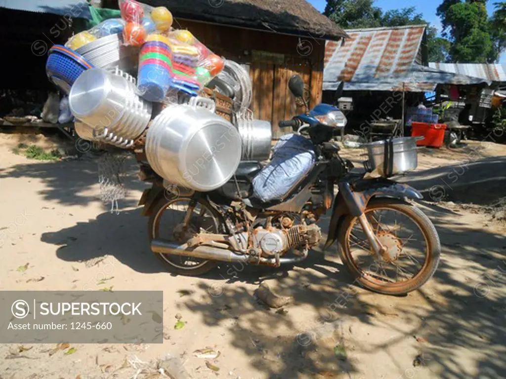 Cambodia, Siem Reap, Motorcycle loaded with lots of pots and pans