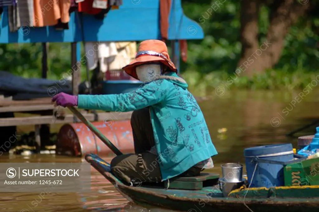 Cambodia, Angor, Woman, rowing in boat in floating market
