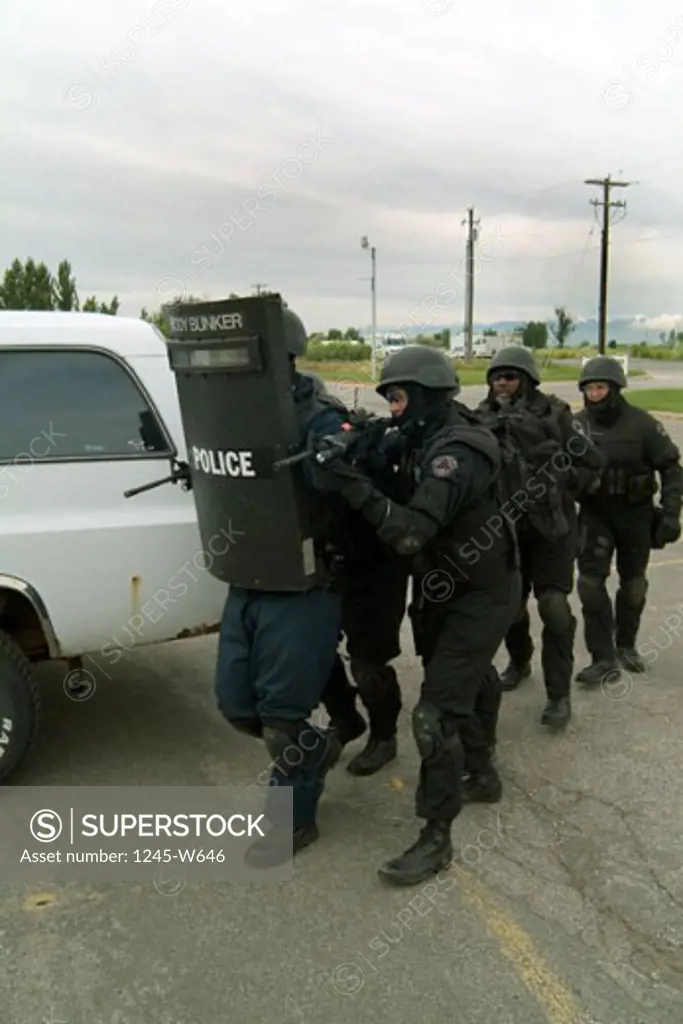 Five SWAT team members taking position