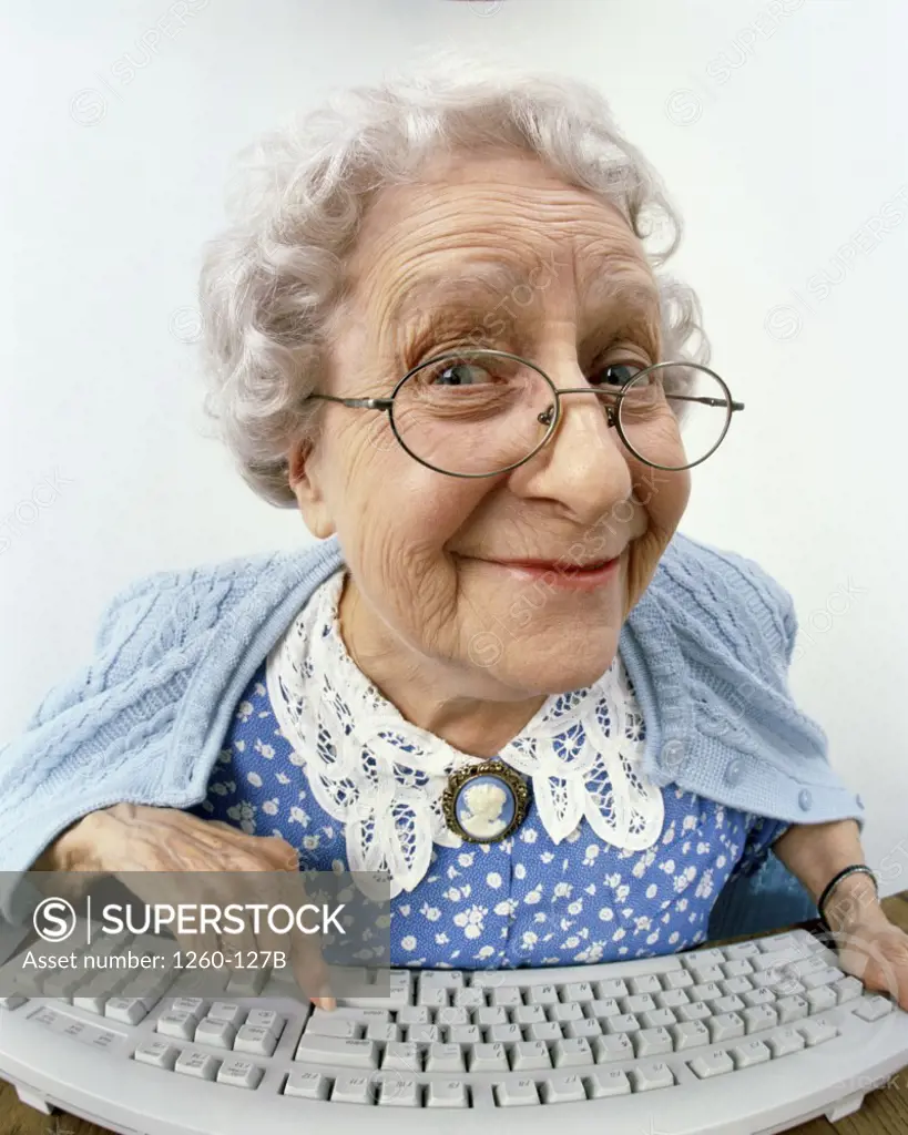 Portrait of a senior woman typing on a computer keyboard