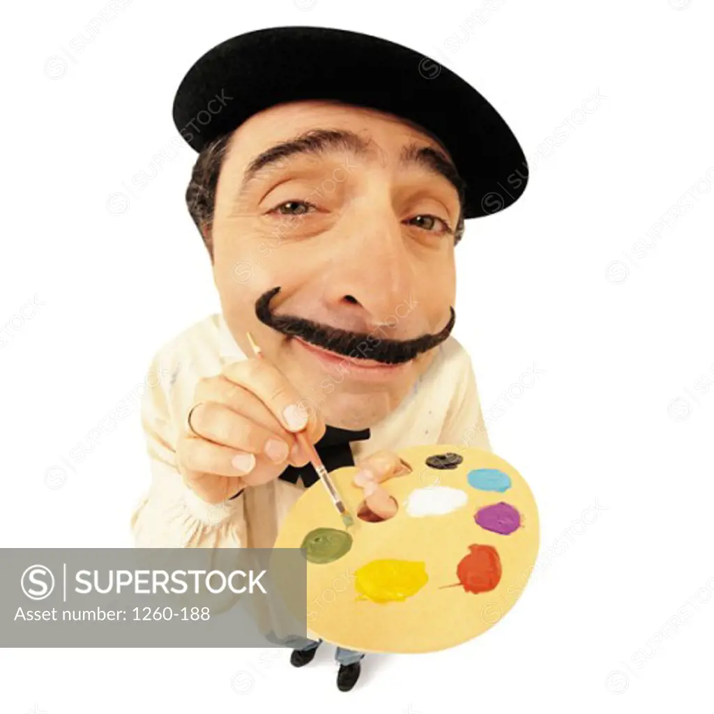 High angle view of a mid adult man holding a color palette
