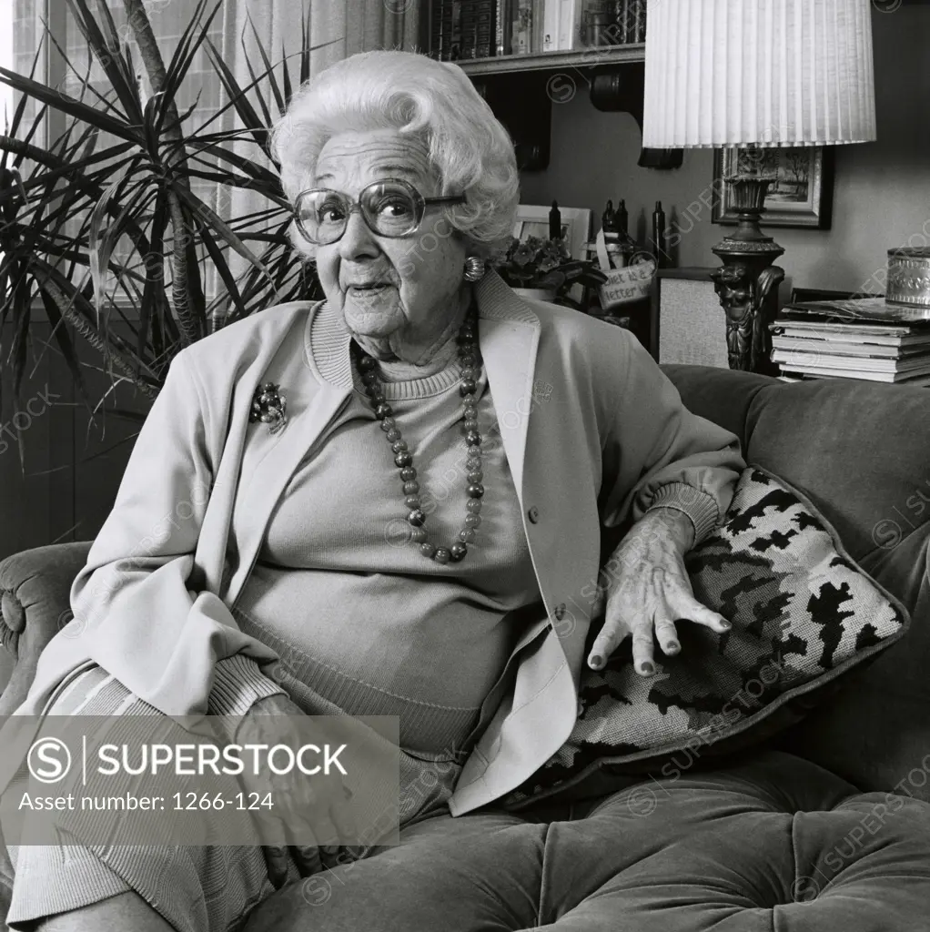 Portrait of a senior woman sitting on a couch smiling