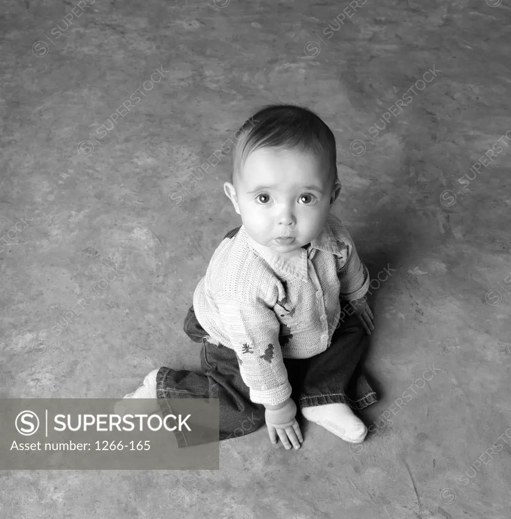 Portrait of a baby boy sitting on the floor