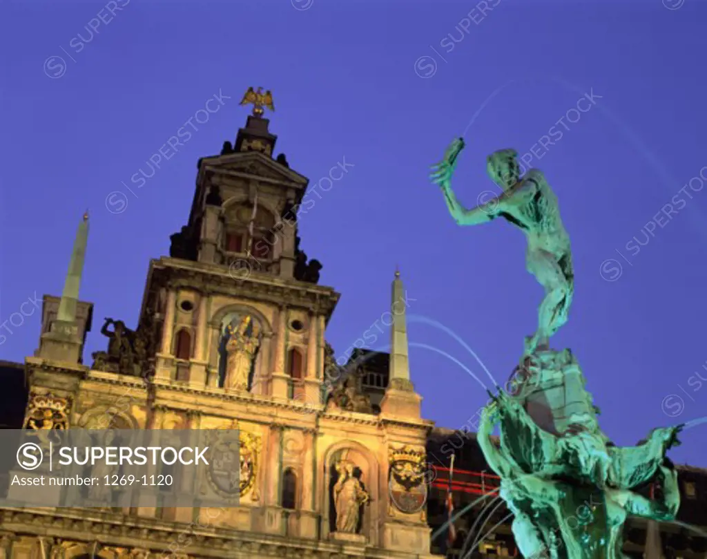 Low angle view of the Brabo Fountain lit up at night, Town Hall, Antwerp, Belgium