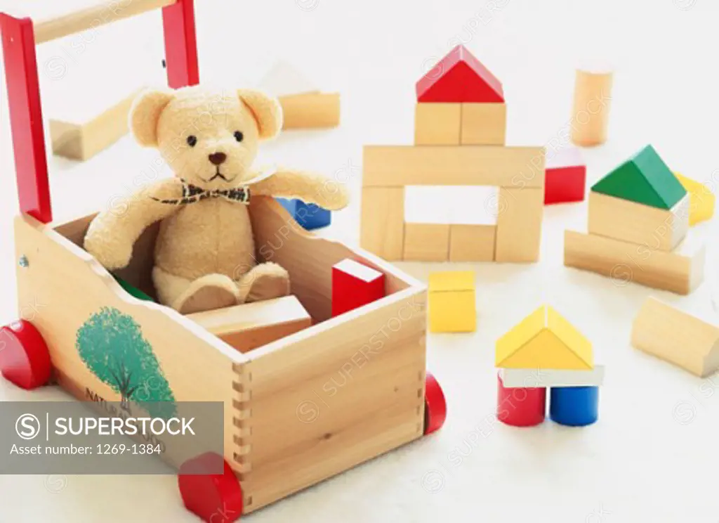 High angle view of a teddy bear and puzzle blocks