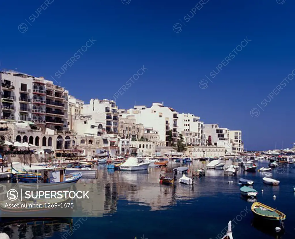 Boats moored in a harbor in front of buildings, St. Julian's, Malta