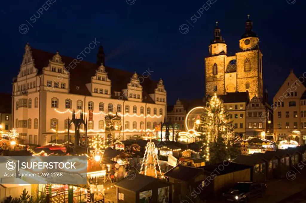 Buildings in a city lit up at night, Christmas Market, Wittenberg, Germany