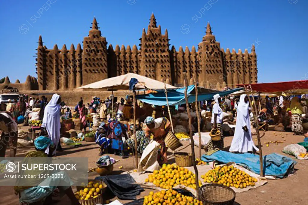 People at market near a mosque, Great Mosque, Djenne, Mali