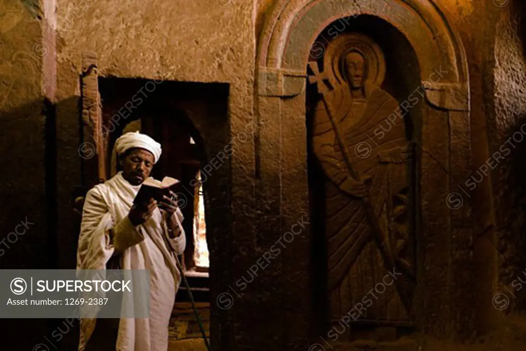 Monk reading the Bible in a church, Golgotha Church, Lalibela, Ethiopia