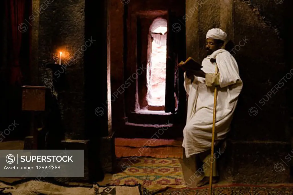 Monk reading the Bible in a church, Golgotha Church, Lalibela, Ethiopia