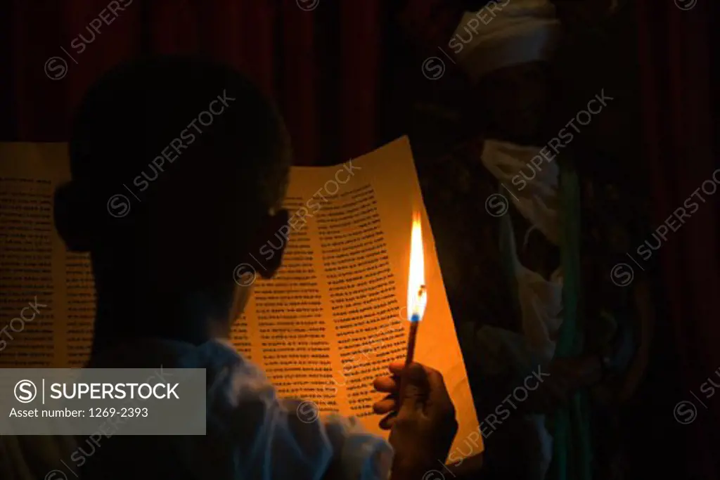 Rear view of a monk reading the Bible in a church, St. Abba Libanos Church, Lalibela, Ethiopia