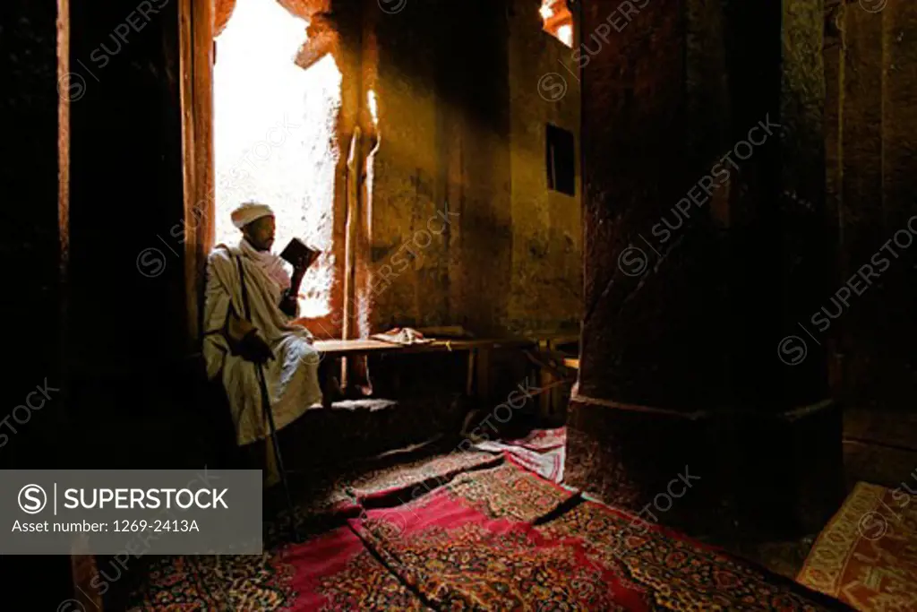 Priest reading the Bible in a church, Golgotha Church, Lalibela, Ethiopia