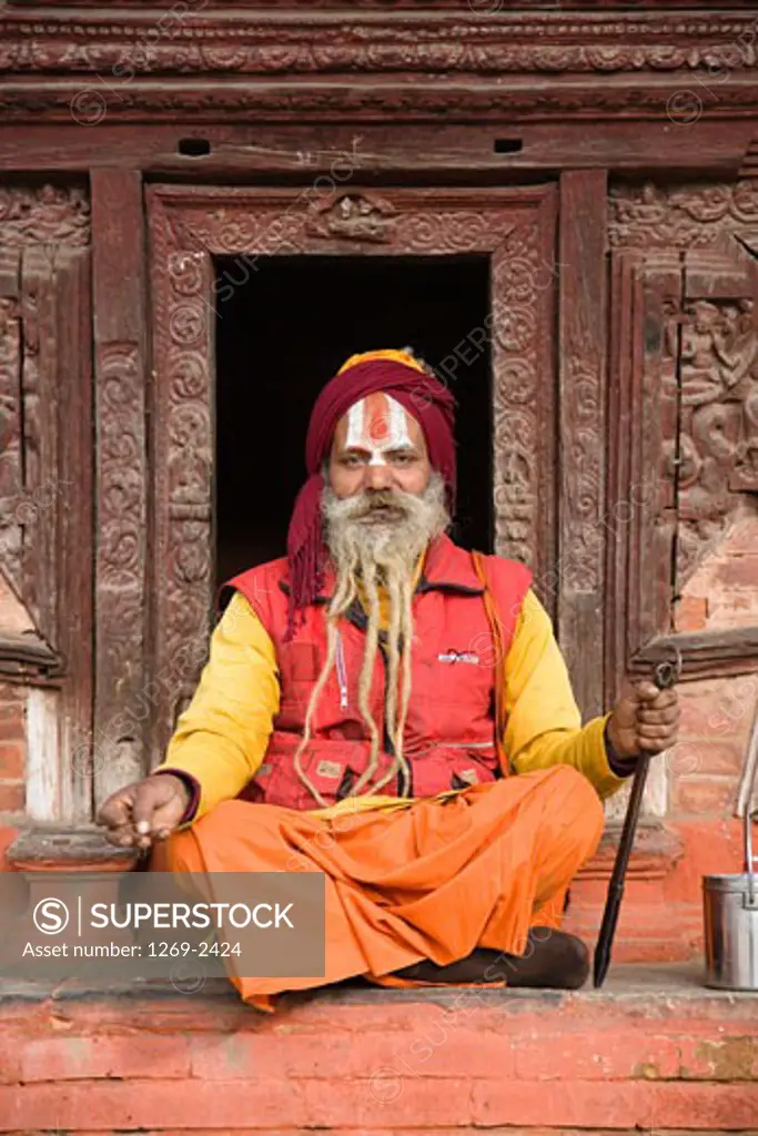 Portrait of a sadhu sitting outside of a temple, Kathmandu, Nepal