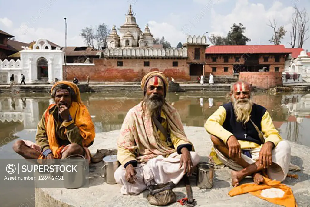 Three sadhus sitting together at a religious festival, Maha Shivaratri, Kathmandu, Nepal