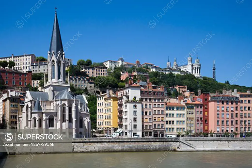Buildings at the riverbank with a basilica in the background, Basilica Notre Dame de Fourviere, Lyon, Rhone-Alpes, France