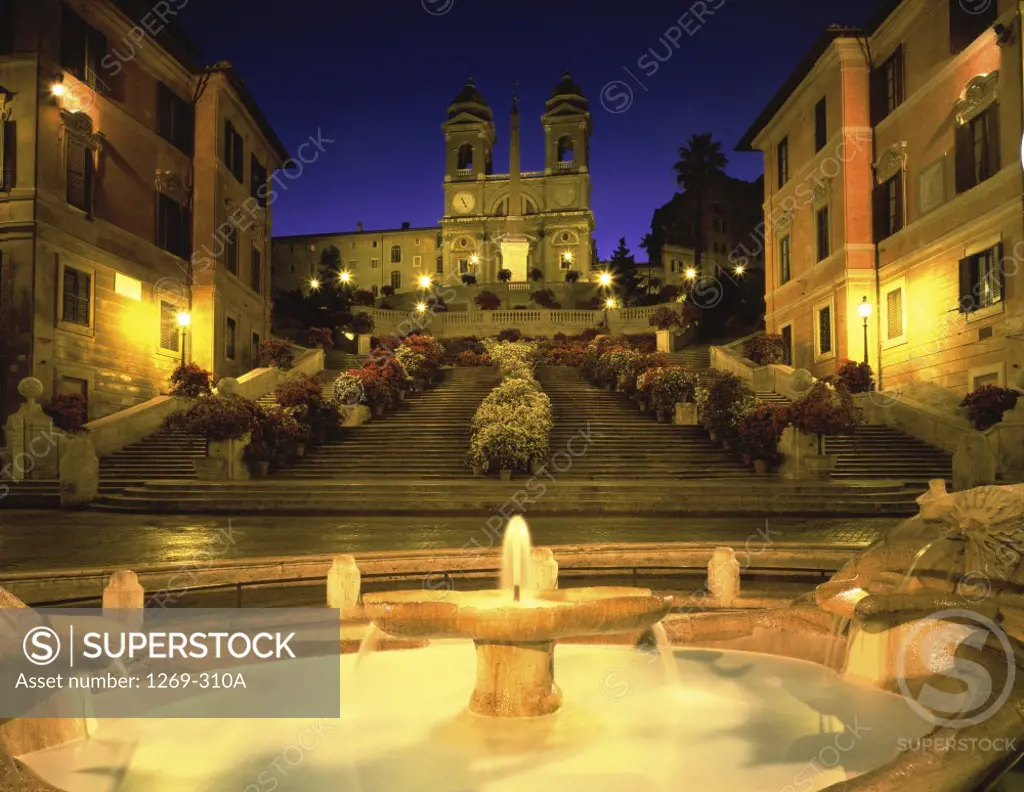 Fountain in front of a church lit up at night, Trinita dei Monti, Spanish Steps, Rome, Italy