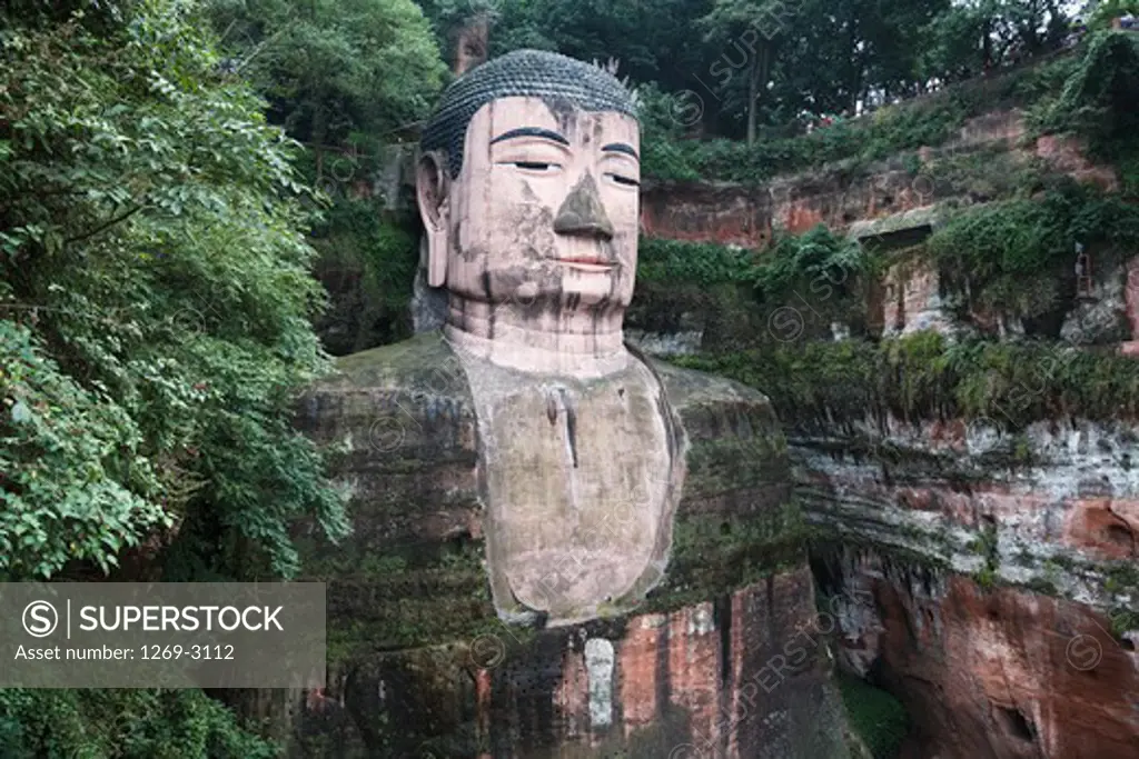 Giant statue of Buddha carved on rock, Leshan Giant Buddha, Leshan, Sichuan Province, China