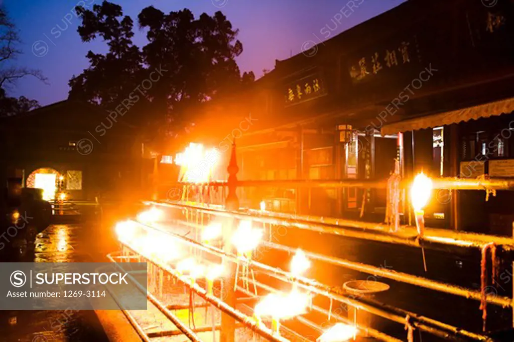 Lamps lit up at night in front of a temple, Baoguo Temple, Mt Emei, Mount Emei Scenic Area, Leshan Giant Buddha Scenic Area, Sichuan Province, China