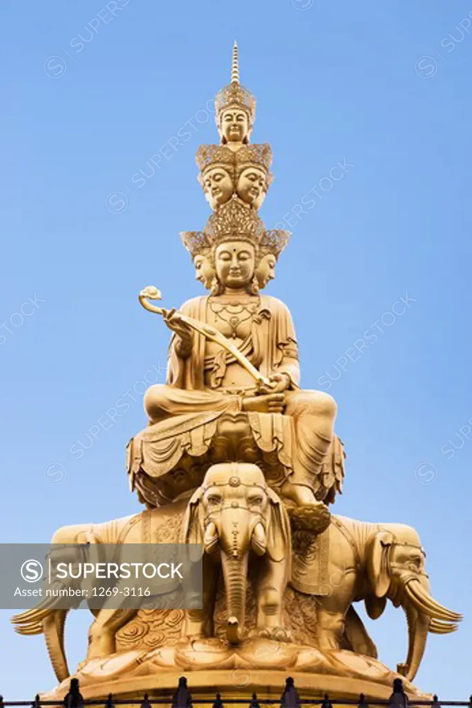 Low angle view of a statue of Buddha on a temple, Jinding Temple, Mt Emei, Mount Emei Scenic Area, Leshan Giant Buddha Scenic Area, Sichuan Province, China